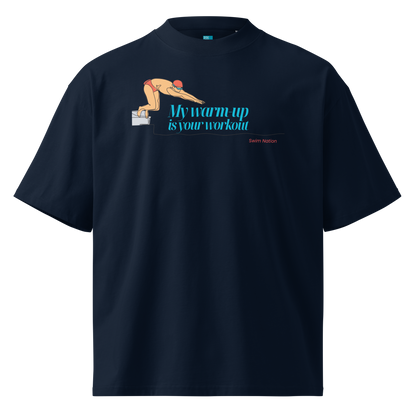 A navy short-sleeve crewneck organic oversized t-shirt by Lane Line Threads featuring a graphic of a swimmer on a diving block with the text 'My warm-up is your workout' in blue and 'Swim Nation' in red below, displayed on a clean white background.