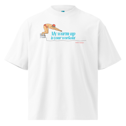 A white short-sleeve crewneck organic oversized t-shirt by Lane Line Threads featuring a graphic of a swimmer on a diving block with the text 'My warm-up is your workout' in blue and 'Swim Nation' in red below, displayed on a clean white background.