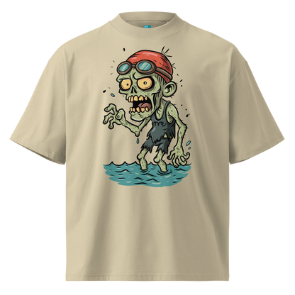 A beige short-sleeve crewneck organic oversized t-shirt by Lane Line Threads, featuring a cartoon graphic of a zombie wearing a red swim cap and goggles, standing in water.