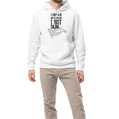 Man wearing a white post swim organic hoodie with open water swim themed text and whale graphics on a white background