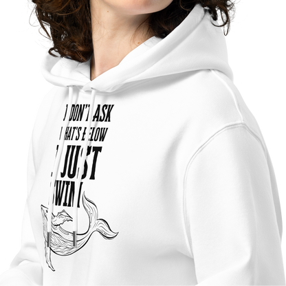 Person wearing a white post-swim organic hoodie with open-water swim themed text and whale graphic design on a white background