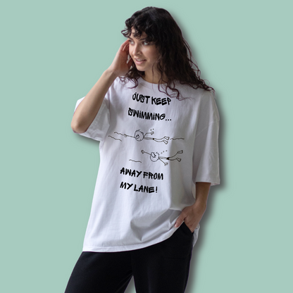 Person wearing a white organic post swim t-shirt with swim-themed text and graphics on a light green background