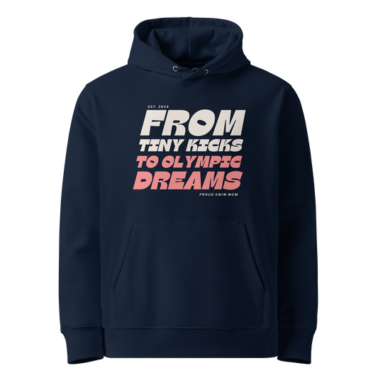 Navy organic swim mom hoodie with “From Tiny Kicks to Olympic Dreams – Proud Swim Mom” text in white and pink; 100% organic certified cotton for eco‑conscious swim families.