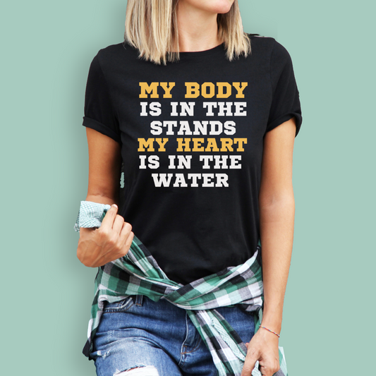 Person wearing a black organic swim mom shirt with a swim motivational quote against a light green background