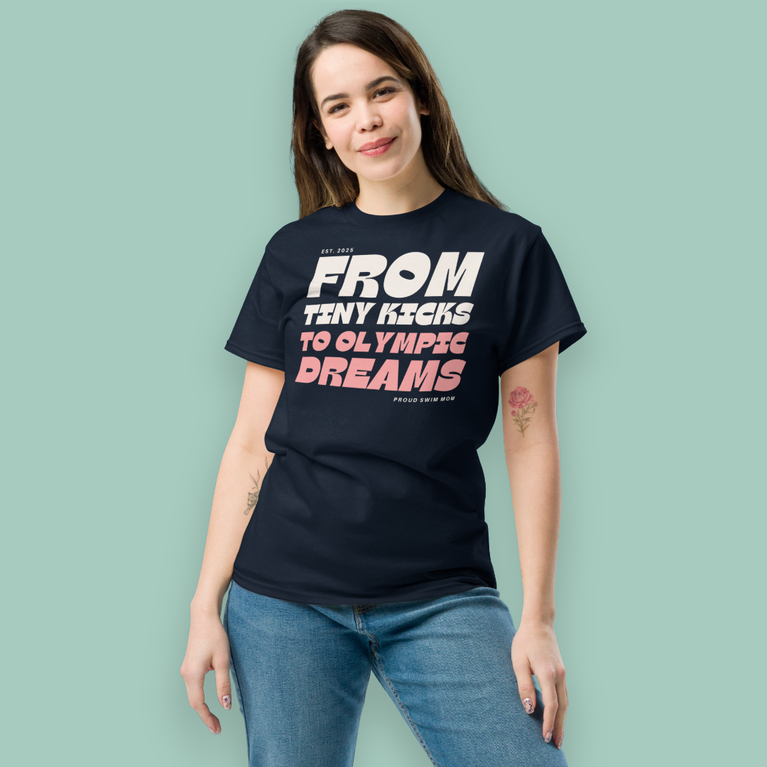 Woman wearing a black swim mom shirt with motivational text on a light green background