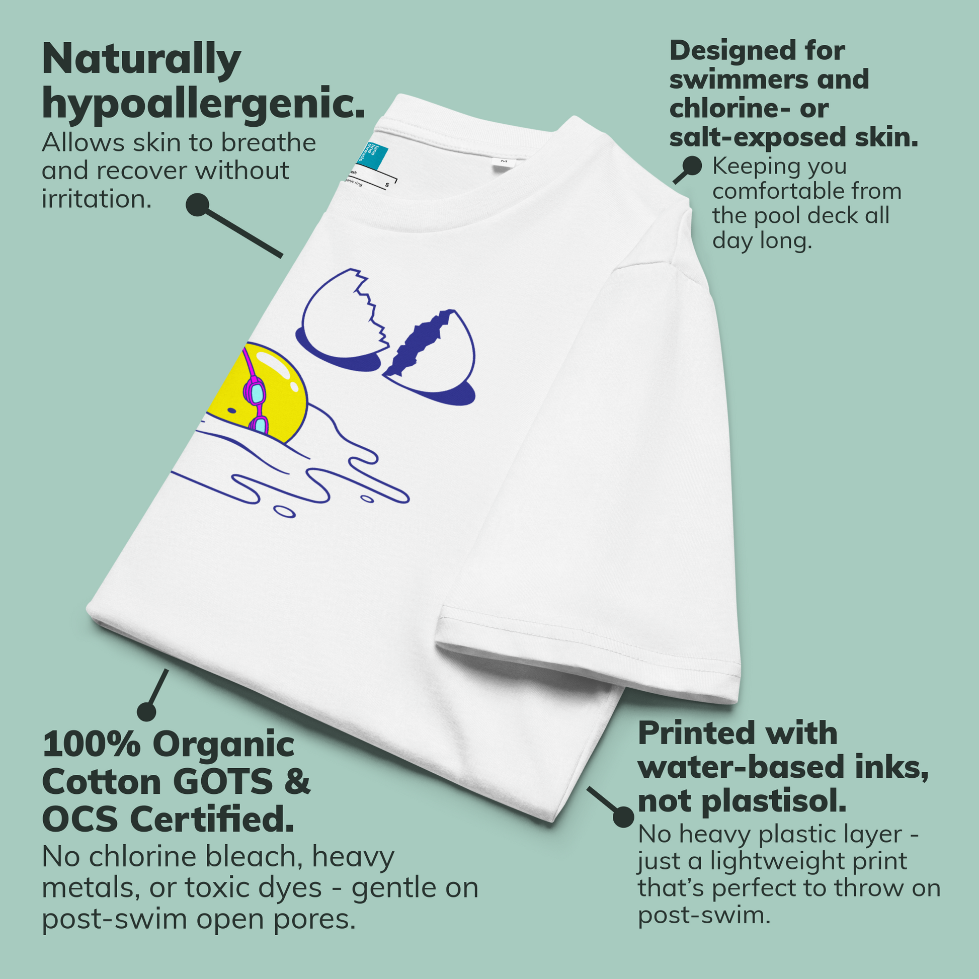 White organic swim shirt with a colorful graphic on a light green background, featuring text about hypoallergenic properties and organic cotton certification.
