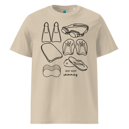 Beige organic swim shirt with line art of swimming gear and “Just Keep Swimming” text – eco-friendly t-shirt for swimmers by Lane Line Threads.