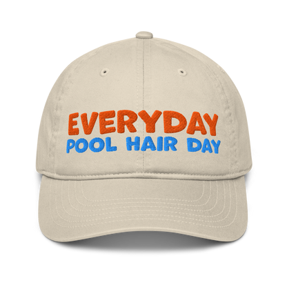 Beige organic baseball cap with bold orange and blue embroidery reading "EVERYDAY POOL HAIR DAY." Made from 100% organic cotton, breathable and eco-friendly