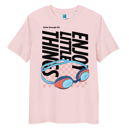 Cotton pink eco-friendly t-shirt featuring vibrant blue and red swimming goggles with a checkered background, and bold black text "ENJOY THE LITTLE THINGS" rotated vertically. Above the goggles, "Glide through life" is in smaller text. Made from 100% organic cotton, this breathable and biodegradable shirt is perfect for competitive swimmers who value comfort, performance, and sustainability. Ideal gift for swim meets or lane-protecting athletes with a sense of humor.