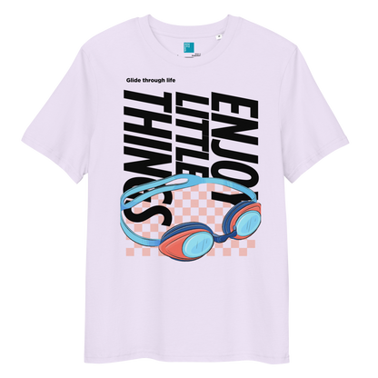 Lavender eco-friendly t-shirt featuring vibrant blue and red swimming goggles with a checkered background, and bold black text "ENJOY THE LITTLE THINGS" rotated vertically. Above the goggles, "Glide through life" is in smaller text. Made from 100% organic cotton, this breathable and biodegradable shirt is perfect for competitive swimmers who value comfort, performance, and sustainability. Ideal gift for swim meets or lane-protecting athletes with a sense of humor.