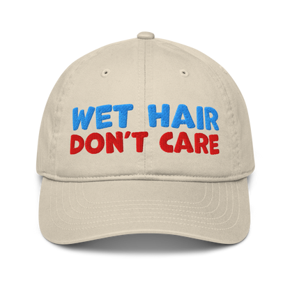 Beige organic baseball cap with curved brim, featuring minimalist embroidery "wet hair don't care" and made from 100% organic cotton. Eco-friendly, breathable, and ideal for swimmers.