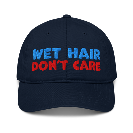 Navy organic baseball cap with curved brim, featuring minimalist embroidery "wet hair, don't care" and made from 100% organic cotton. Eco-friendly, breathable, and ideal for swimmers. 